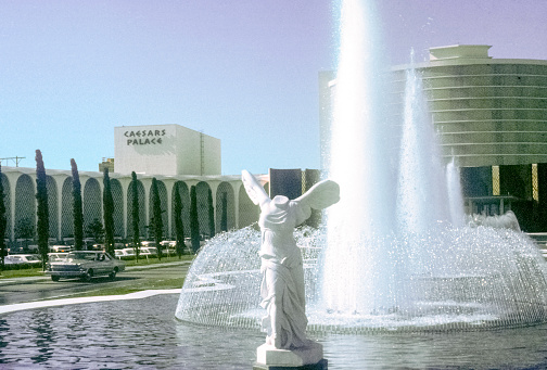Las Vegas, Nevada- 1966: A vintage 1966's negative film scan of the Caesar's Palace hotel and casino sign and fountains in Las Vegas, Nevada.