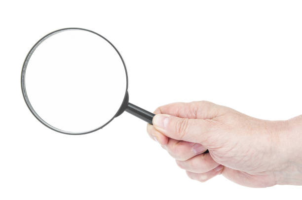 istock Magnifying lens in hand close up on a white background 1486347730