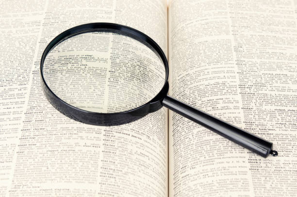 istock Magnifying glass and dictionary page close up 1486347786