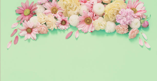 istock frame of flowers on green background 1486360677