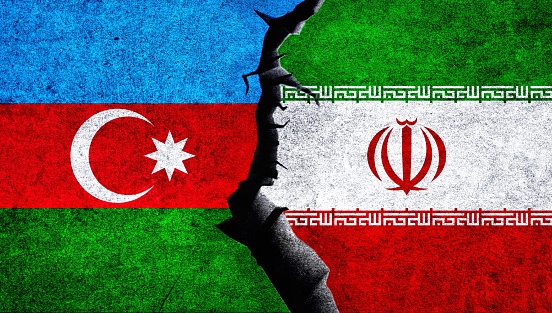 Iran vs Azerbaijan concept flags on a cracked wall. Azerbaijan Iran political conflict, war crisis, relationship concept
