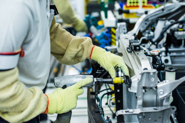 employee screwing in car parts