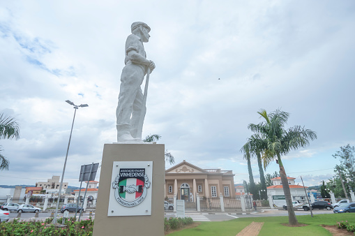 Vinhedo-sp,brazil-April 27,2023 immigrant museum in the background with sculpture representing the immigrant in front,statue symbol of the city of vinhedo sp.