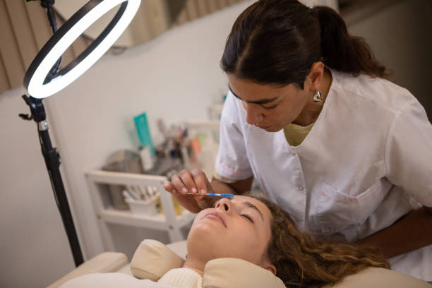 istock Young woman during eyebrow lamination procedure 1486374174