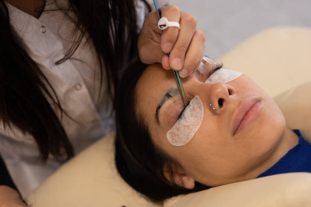 istock Woman during eyelash extension procedure 1486374273