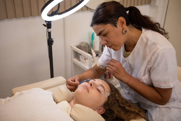 istock Young woman during eyebrow lamination procedure 1486374318