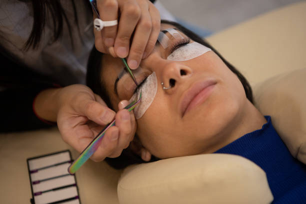 istock Woman during eyelash extension procedure 1486374546