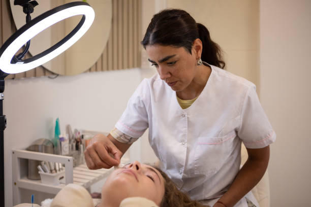 Young woman during eyebrow lamination procedure
