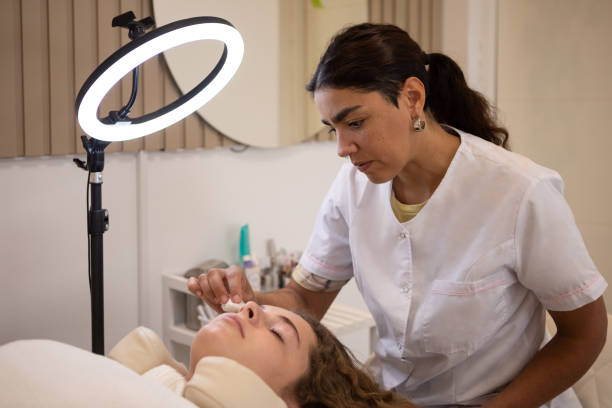 istock Young woman during eyebrow lamination procedure 1486374742