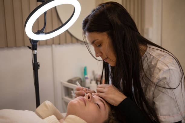 istock Young woman during eyebrow lamination procedure 1486375666