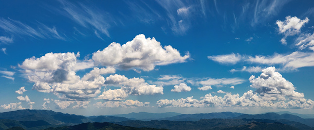 Cloudscape. The horizon between heaven and earth is composed of a multitude of clouds above the mountain peaks.