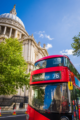 Iconic red double decker bus below St. Paul’s Cathedral in the heart of London, the UK’s vibrant capital city.
