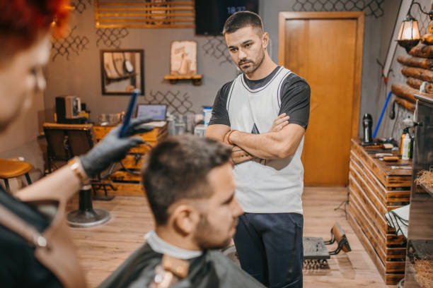 istock Female barber training in a barber salon 1486394400