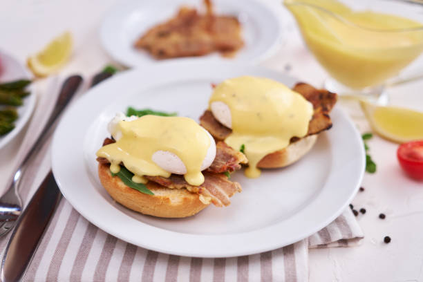 istock Tasty eggs Benedict, hollandaise sauce and bacon 1486412439