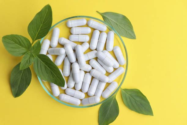istock herbal pills or vitamins and green leaf, bio supplement 1486413398