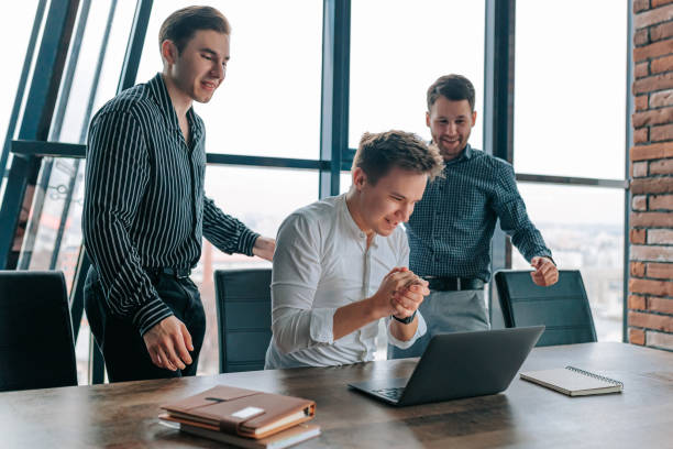 istock Satisfied colleagues working on a laptop and achieving their goals 1486413767