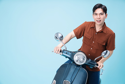 Image of yougn Asian man on motorbike