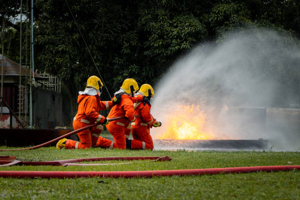 istock Firefighter Concept. Fireman using water and extinguisher to fighting with fire flame. firefighters fighting a fire with a hose and water during a firefighting training exercise 1486428406