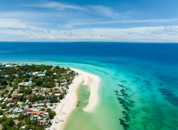 Aerial drone of tropical sandy beach with palm trees. Bantayan island, Philippines.