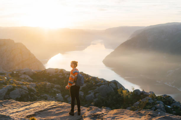 istock Woman standing on Preikestolen and looking at view 1486450798