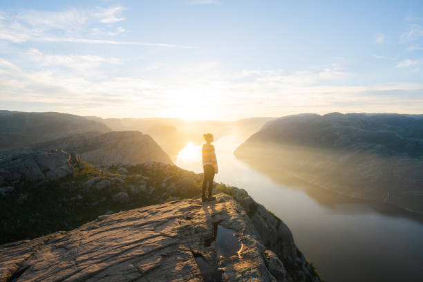 istock Woman standing on Preikestolen and looking at view 1486450923