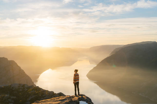 istock Woman standing on Preikestolen and looking at view 1486450930