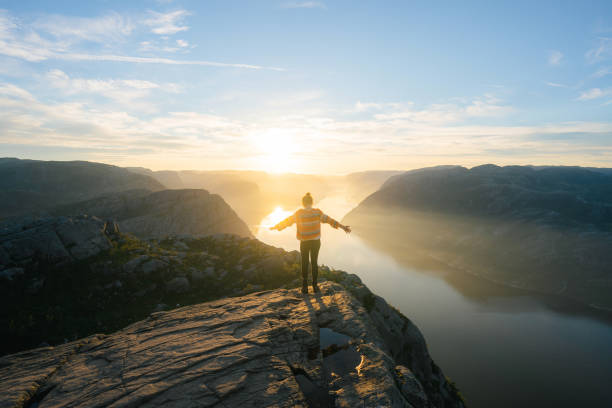 istock Woman standing on Preikestolen and looking at view 1486451159
