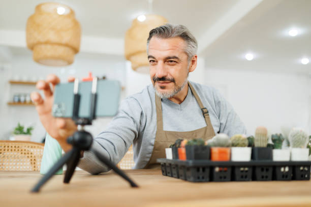 istock Mature man blogger having live streaming on smartphone. 1486456806