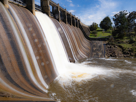 Water spilling over spillway at dam wall