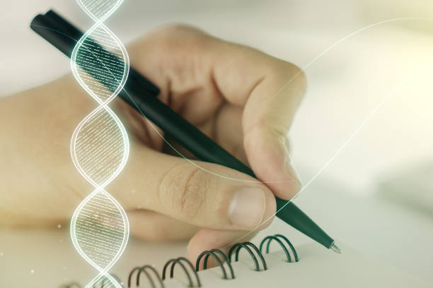 istock Double exposure of creative DNA hologram and man hand writing in notebook on background. Bio Engineering and DNA Research concept 1486466149