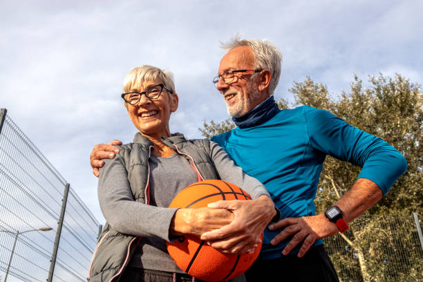 istock Mature couple play basket ball on playground 1486470341