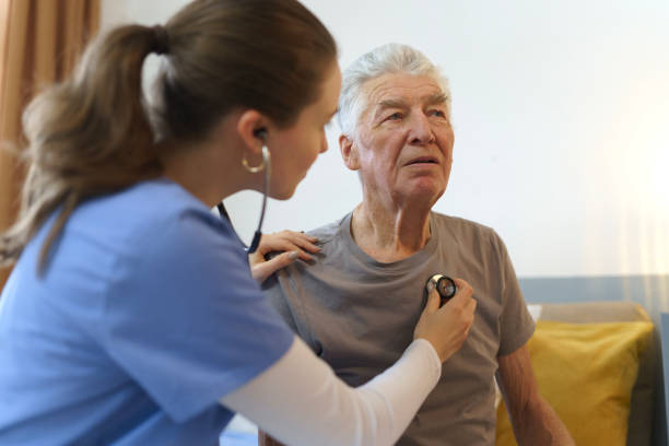 istock Young nurse checking elderly senior in his home. 1486472880