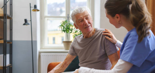 istock Young nurse checking elderly senior in his home. 1486472960