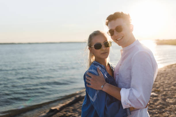 istock Young cupple cuddling during sunset at sea. 1486474168