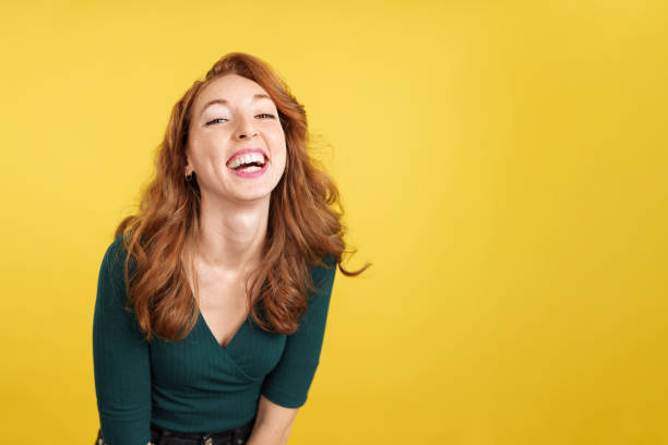 istock Happy redheaded woman laughing and looking at camera 1486474852