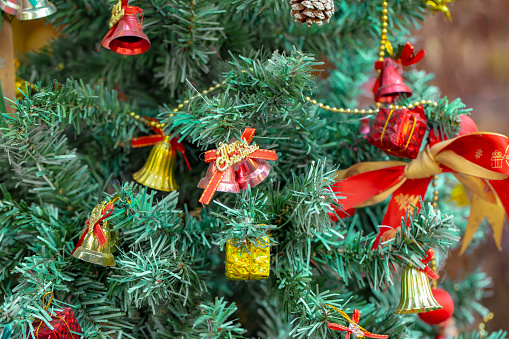 Close up photo of fake Christmas tree decorated with decorations.