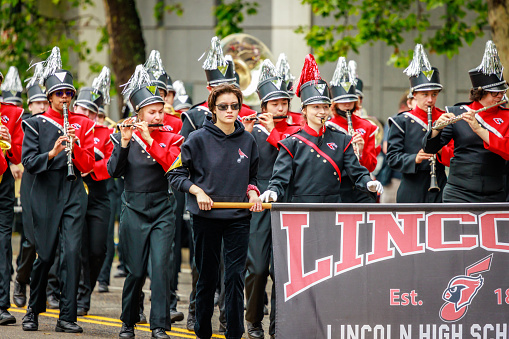 Portland, Oregon, USA - June 11, 2022: Lincoln High School Marching Band in the Grand Floral Parade, during Portland Rose Festival 2022.