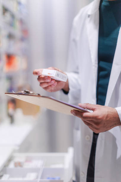 istock Pharmacist checking medicine stock in a pharmacy. 1486483925