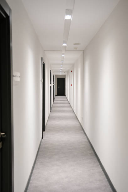 istock Endless and white corridors of a white-collar office 1486487425