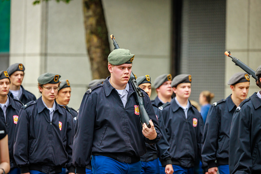 Soldiers standing in uniform, saluting.