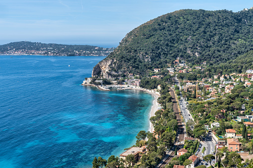 This stunning photo captures the beauty and serenity of a beach along the French Riviera near the charming town of Eze. The crystal-clear waters of the Mediterranean Sea gently lap against the pristine shoreline, creating a peaceful and inviting atmosphere. The photo captures the essence of the French Riviera, with its luxurious ambiance and natural beauty. Whether you're a lover of sun, sand, and sea, or simply seek a moment of tranquility, this image is sure to transport you to a place of relaxation and rejuvenation.