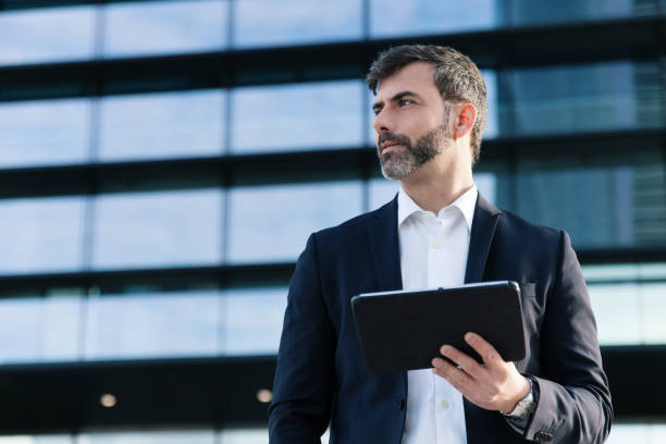 Businessman holding tablet in financial district