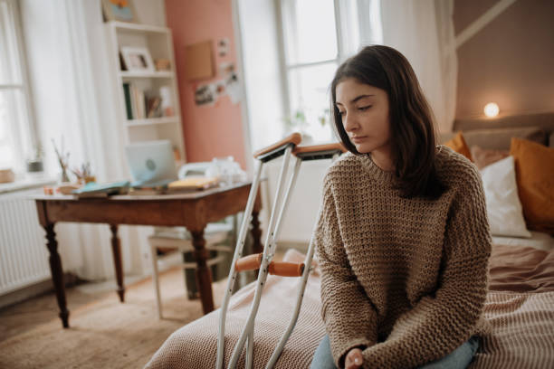 istock Unhappy girl with broken leg in her room. 1486495193