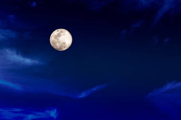 istock Full moon in the night dark sky with light clouds , copy space 1486501919