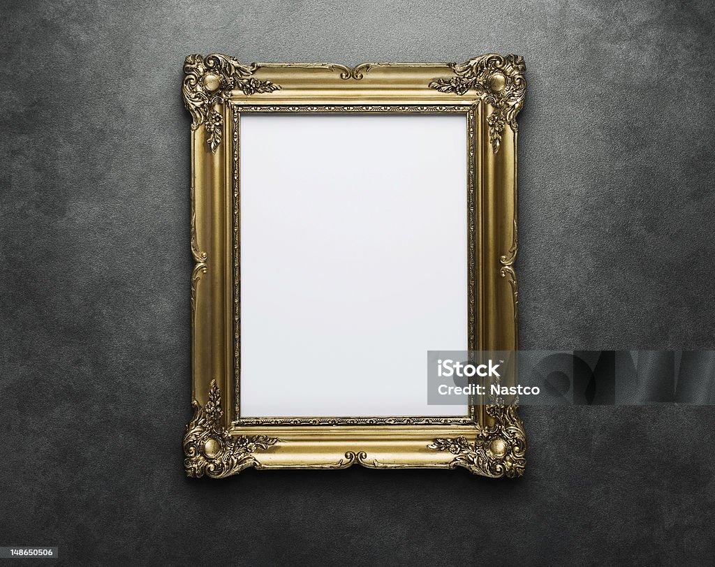 Gold frame at the wall Ornate gold frame at the concrete wall with clipping path for the inside Picture Frame Stock Photo