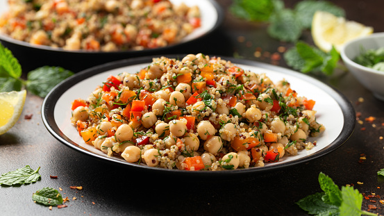 Chickpea Salad with Quinoa, sweet red pepper, herbs and lemon. Healthy food.