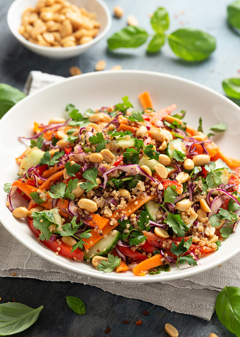 Asian Quinoa salad with fresh vegetables, peanuts and herbs. Healthy food