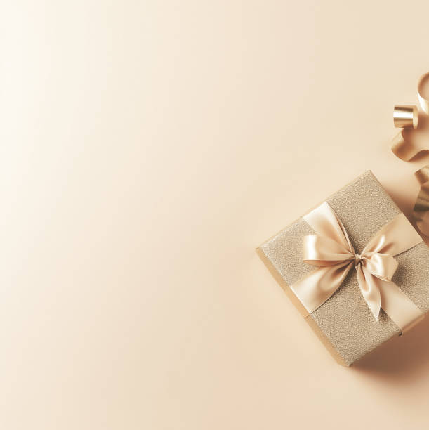 istock Gift box with gold ribbons on pastel-powder background with blank space for text. Gift for mother's day, birthday, March 8. 1486507593