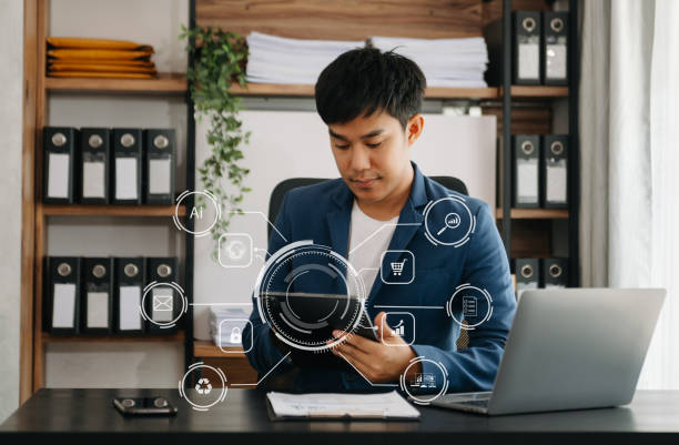 istock businessman hand working with mobile phone and modern compute with VR icon diagram at office in morning light 1486511089