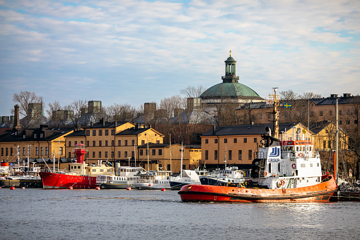 Beautiful light from sunset over Stockholm city center at springtime. Lot of boats docked in harbor
